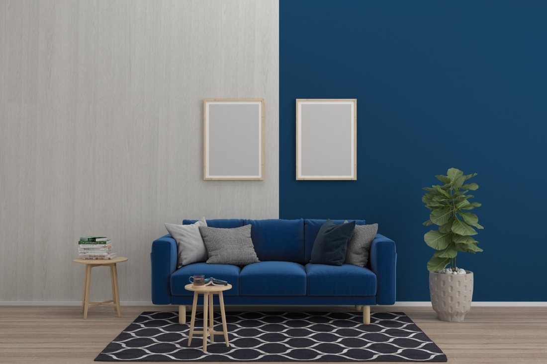 Living room with a two-tone wall in grey and deep blue above a blue sofa