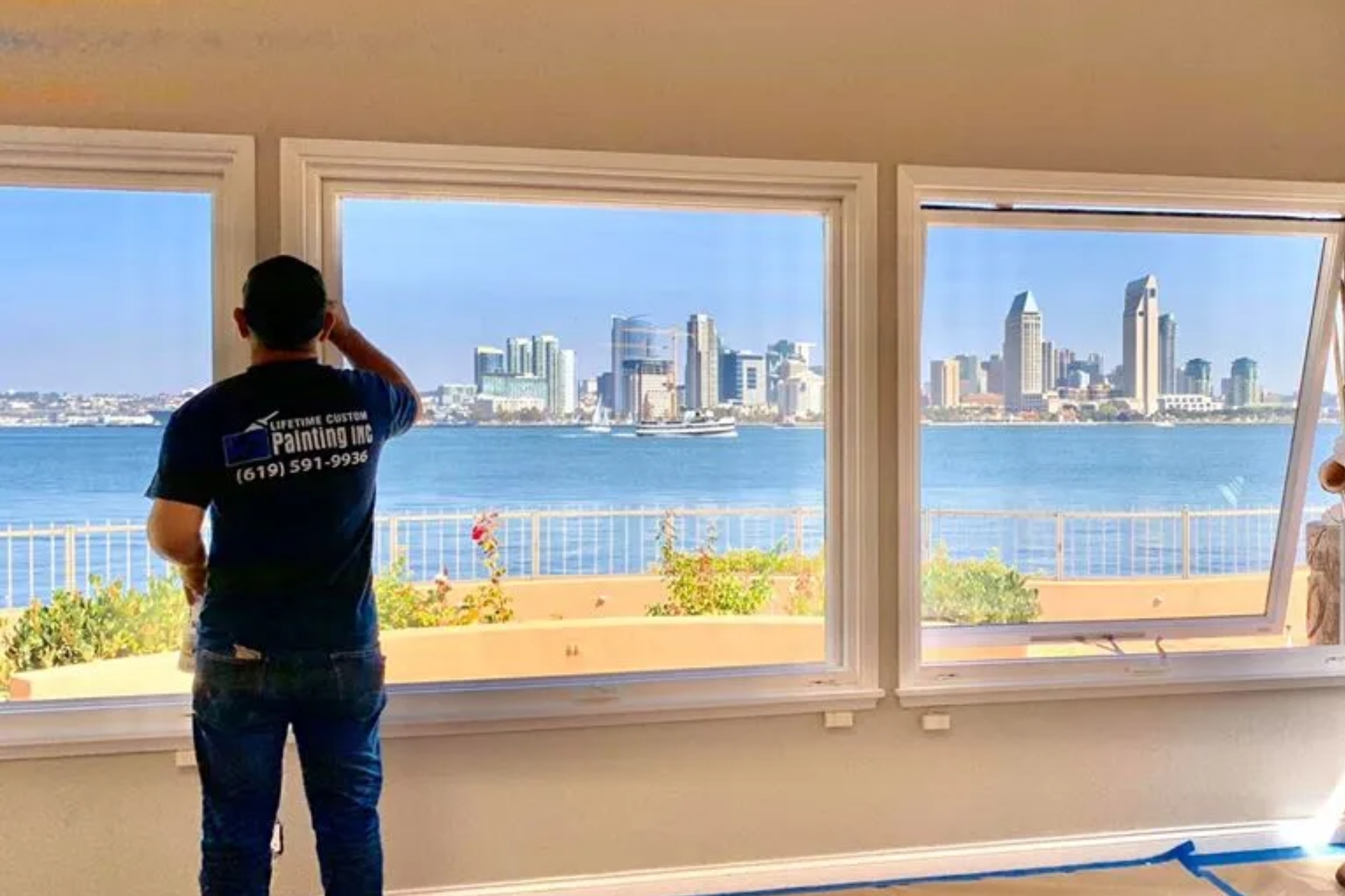 Two painters painting the windowsill